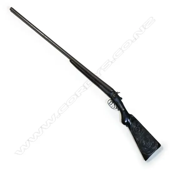 An old Liege Arms Co. Ltd. double barrel 12-gauge shotgun with Māori carved stock,